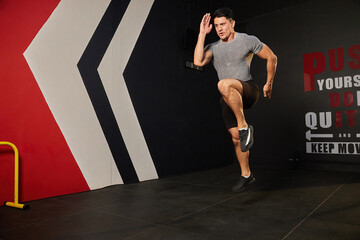 sportsman jumping up and training in the gym