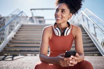 Fitness, headphones and smartphone with woman on stairs thinking of workout, exercise or training website, blog or social media. Mental health technology, sports music and happy black woman in city