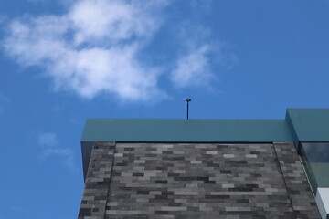 Perspective and lower angle view of the hotel building against the bright blue sky