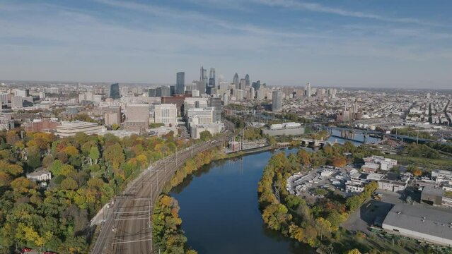 Aerial footage in autumn showing the Schuylkill River meandering towards downtown Philadelphia in the afternoon.