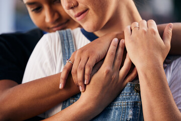 Hands, love and lgbt with a woman couple hugging outdoor for romance, dating or non binary affection. Hug, date and gay with a gender neutral female and partner sharing an intimate moment together