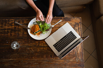 Сlose-up hands holding a plate of food, top view.