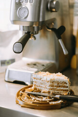 leftover cake on the kitchen table, dirty knife. coffee machine. dessert with coffee in an authentic setting