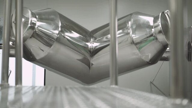 Production of medicines and tablets, view of a special chrome plated mixer tank for mixing powder mixture preparation and medicinal ingredients, the process of rotation, pharmacy and pharmacology.