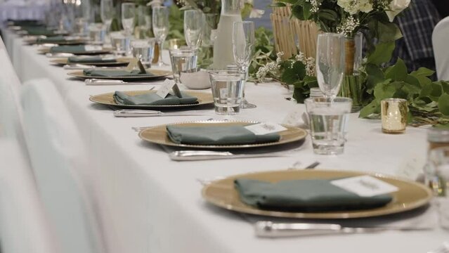 Elegant wedding dining table silverware arrangement on a long horizontal table