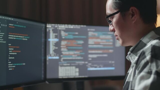 Close Up Of Asian Male Programmer Creating Innovative Software Engineer Developing App, Program, Video Game On Desktop Computer At Home. Terminal With Coding Language 
