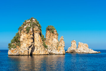 Sea stacks of Scopello, three outcrops located in the northwest of the coast of Castellammare del Golfo in front of the ancient Tonnara of Scopello a famous sight in Sicily