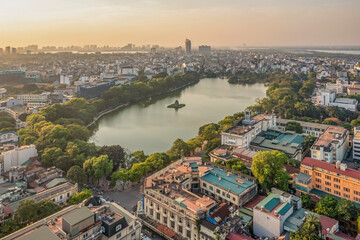 Obraz premium Hanoi, Vietnam - May 04, 2022: Top view aerial photo from flying drone of Hoan Kiem lake, Hanoi City with development buildings, transportation, energy power infrastructure. 