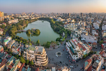 Hanoi, Vietnam - May 04, 2022: Top view aerial photo from flying drone of Hoan Kiem lake, Hanoi City with development buildings, transportation, energy power infrastructure. 