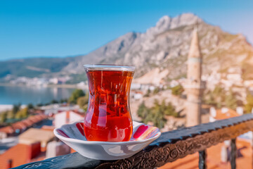 Delicious and fragrant Turkish tea in a traditional authentic bardak glass against the backdrop of...