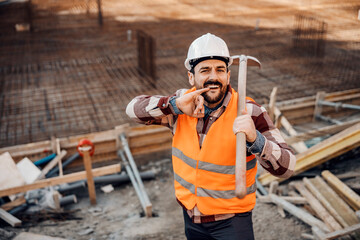 Portrait of a builder on a break with shovel on shoulder.