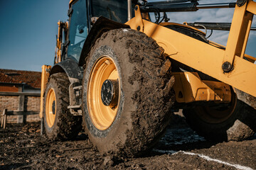 Close up of a backhoe tire on construction site.
