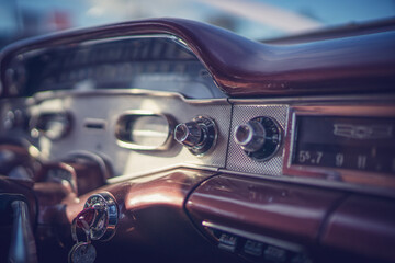 Obraz premium Close up of 1955 Chevrolet interior dashboard with radio knobs and dials. 