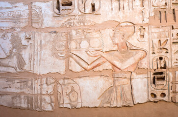 Part of the wall of ancient Egypt art close-up, detail of a bas-relief in the Temple of Medinet Habu in Luxor, Egypt