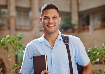 Face portrait, man and university student in campus ready for learning. Education, college and happy male learner from Brazil holding book for knowledge, studying and literature research outdoors. - obrazy, fototapety, plakaty