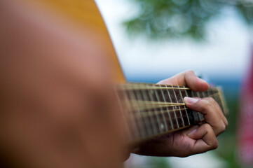 Isolated Acoustic Guitar's Fretboard with Fingers in Action