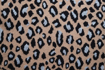 Leopard skin texture pattern woolen sweater, background. Close up.