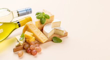 Various cheese on board and white wine