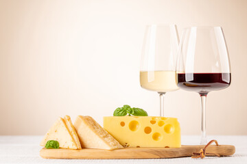 Various cheese on board, red and white wine