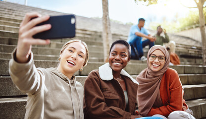 Women, diversity or phone selfie on university stairs, school steps or college campus bleachers for social media or profile picture. Smile, happy or bonding students on mobile photography technology