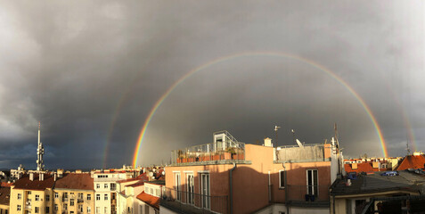 Panoramic double rainbow over the city