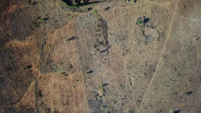 Aerial zenithal view of the Manyattas, traditional houses of the Karamoja region of Uganda, Africa. High quality 4k footage.