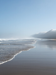 Cofete beach in Fuerteventura. Virgin beach under the foggy mountains landscape