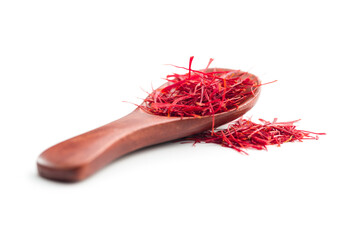 Dried saffron spice in spoon isolated on white background.
