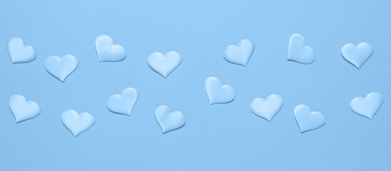 Blue border with blue silk hearts, flat lay. Valentine's Day. Banner