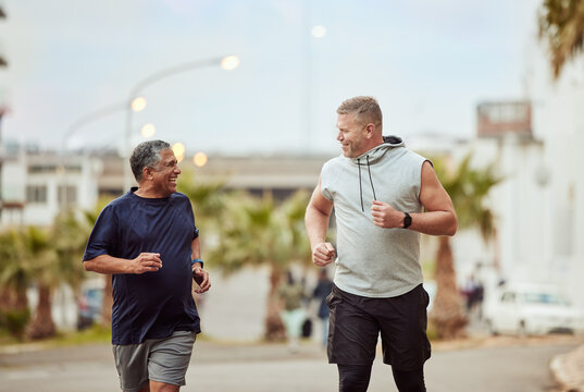Running, friends and senior men in city for fitness, healthy lifestyle and outdoor wellness. Happy mature males, urban training and exercise in street for energy, power and sports workout together