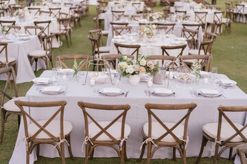 outdoor event, white chairs and tables placed outside