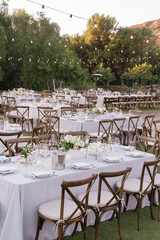 outdoor event, white chairs and tables placed outside