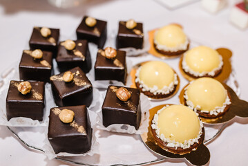 Sweets. Candy bar with desserts for celebrating birthday, baptism, wedding. Desserts on a golden plate. Top view.