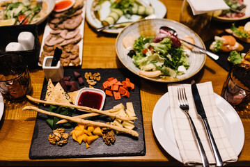 Served dinner table in restaurant interior. Wedding festive dinner. Delicious dishes on the table in the restaurant. Serving table, birthday setting. Top view.