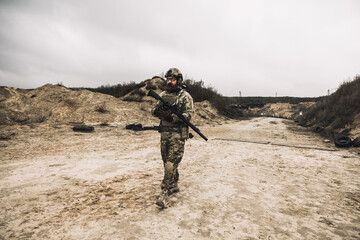 A man in military uniform with a rifle