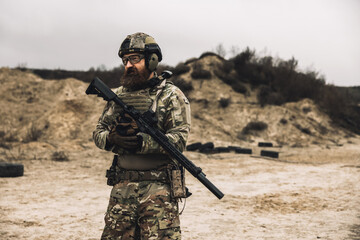 A man in military uniform with a rifle