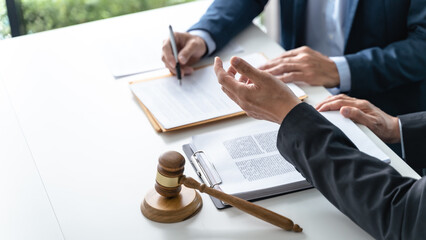 Lawyer Legal counsel presents to the client a signed contract with gavel and legal law. justice and lawyer Business partnership meeting concept. - obrazy, fototapety, plakaty