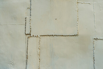 A close-up of an uneven steel patch sloppily welded onto a steel sheet with a clearly visible seam.