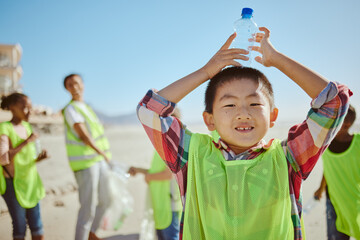 Child, portrait and plastic bottle on nature beach, waste management collection and ocean school cleanup. Smile, happy kids and volunteering in climate change cleaning and community service recycling