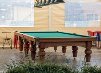 Interior design of a billiard table in the courtyard under a canopy