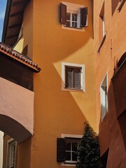 Old historic architecture in Italy. Traditional European old town buildings. Aesthetic summer travel concept. Sunlight shadows