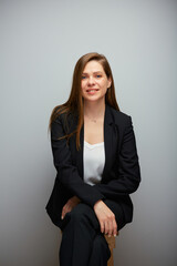 Obraz premium Young smiling business woman in black business suit. isolated portrait.