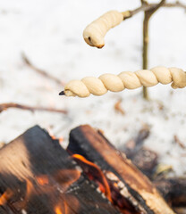 Stick bread roasting over a fire 