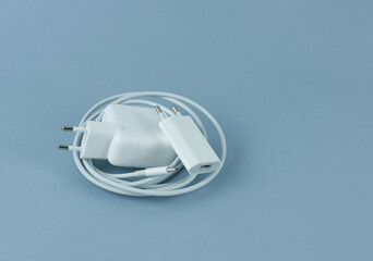 Charger for tablet and phone on blue background. Charger for your phone.

