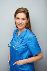 Smiling doctor woman or nurse in blue medical suit. Isolated portrait of medical worker.