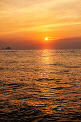 Beautiful sunset landscape with dramatic sky, sun and sea water