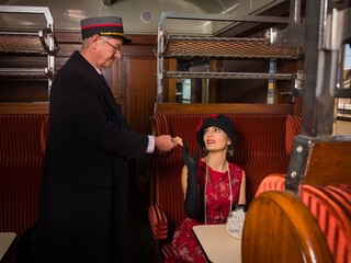 Vintage train conductor checking ticket