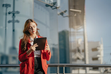 Fototapeta premium Smiling young Asian business woman leader entrepreneur, professional manager holding digital tablet.