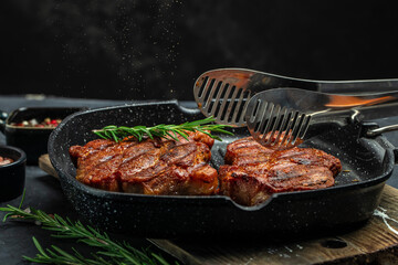 Grilled pork steaks, pork neck with herbs and spices on the grill pan, Restaurant menu, dieting, cookbook recipe place for text