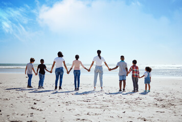 Support, back and big family holding hands at the beach, summer walking and travel holiday in nature of Portugal. Hope, love and women with affection for adopted kids on a vacation at the ocean